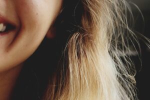 side of woman's face up close smiling